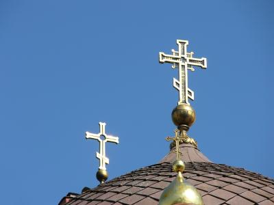 Gold crosses against a deep blue sky offer up a special visual treat in the midst of a vibrant cityscape. 